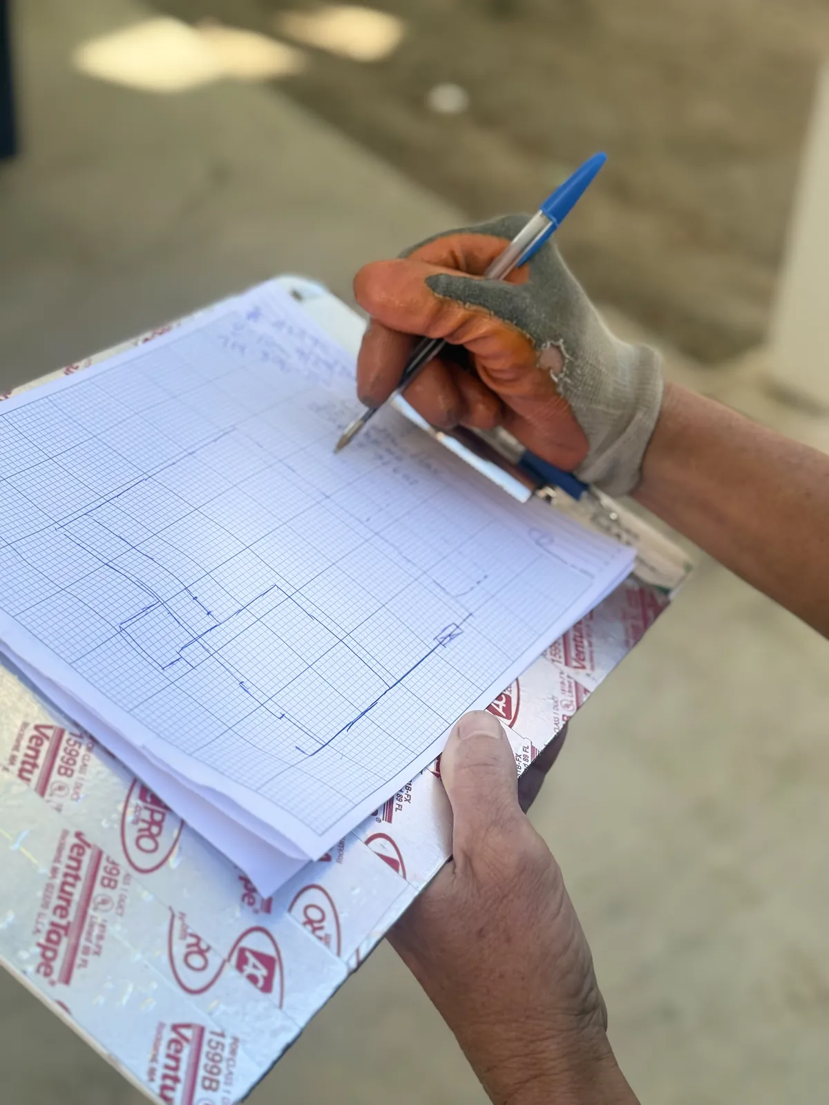 Technician drawing an inspection diagram on a property sketch during a San Clemente termite inspection