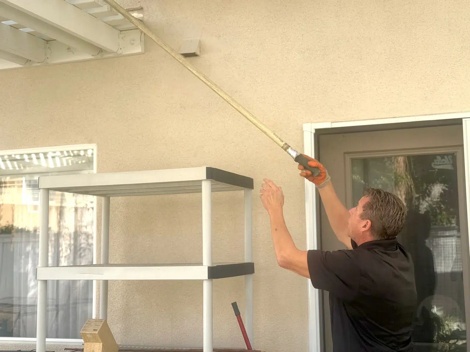 Treebark technician inspecting a roof eave with an extension tool in San Clemente, CA