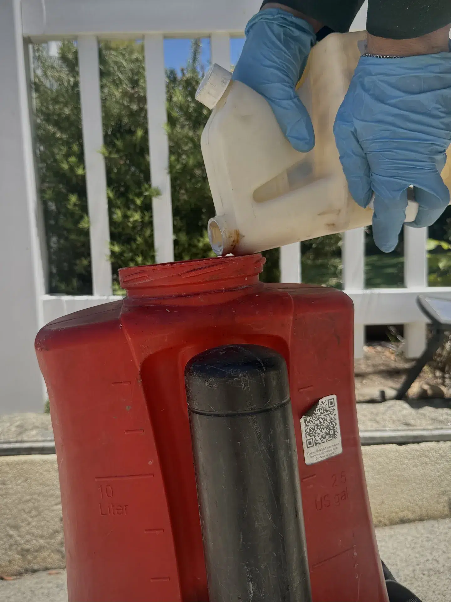 Anaheim technician applying termite treatment from portable sprayer