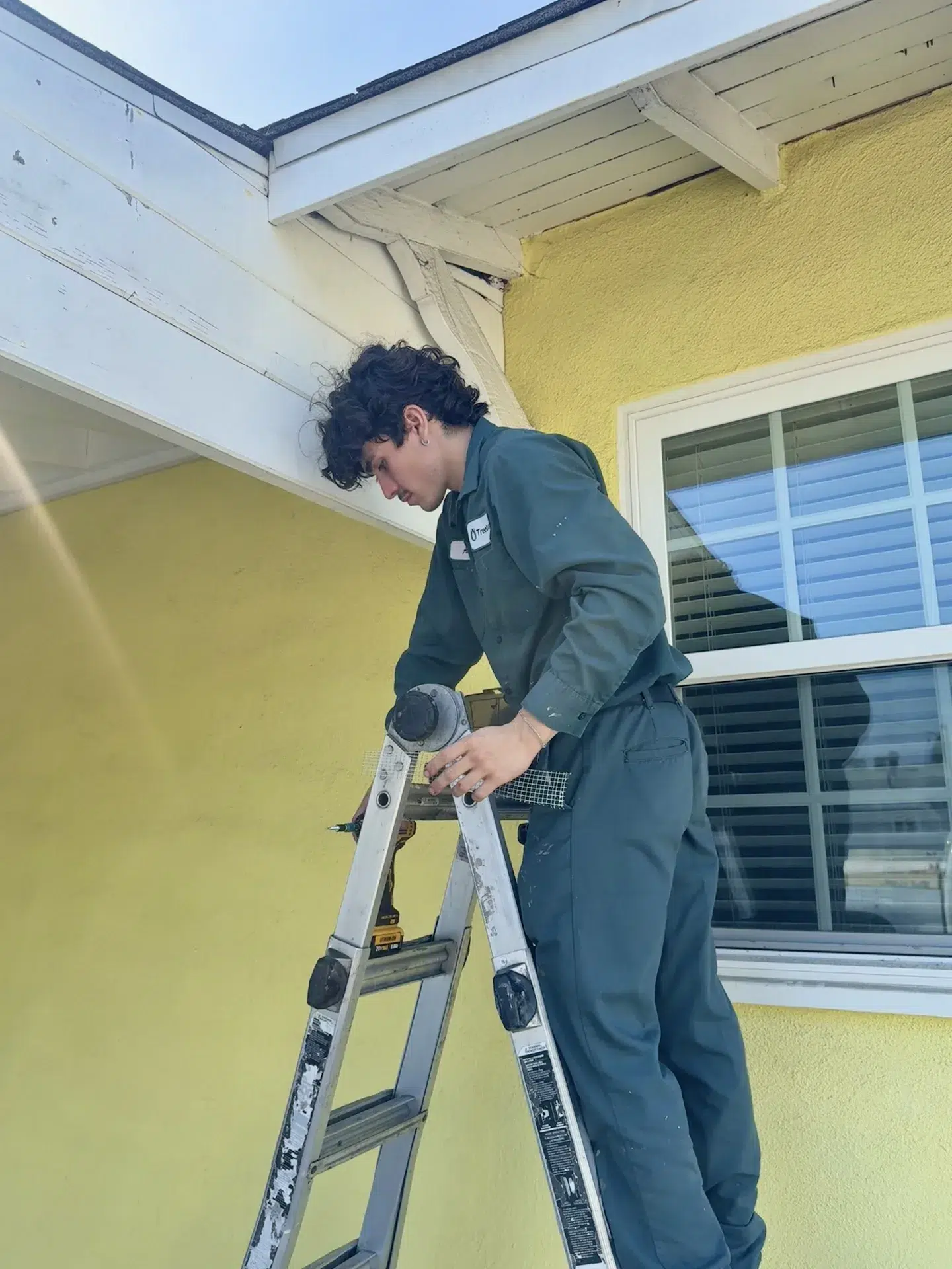 Treebark pest control technician treating a Villa Park home exterior